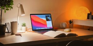 macbook pro on white wooden desk
